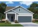 Charming single-story home featuring a craftsman-style facade, attached two-car garage, and manicured lawn at 31400 Pendleton Landing Cir, Wesley Chapel, FL 33545