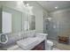 Modern bathroom with a large mirror, granite countertop, and glass enclosed shower at 325 5Th S Ave # 9, St Petersburg, FL 33701