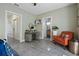Inviting bedroom with an adjacent bathroom, featuring an orange chair, modern desk, and concrete flooring at 325 5Th S Ave # 9, St Petersburg, FL 33701