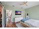 Relaxing bedroom with hardwood floors, ceiling fan, and ensuite bathroom at 325 5Th S Ave # 9, St Petersburg, FL 33701