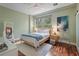 Well-lit bedroom with a queen-size bed, modern decor, and hardwood flooring at 325 5Th S Ave # 9, St Petersburg, FL 33701