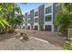 Modern townhouse complex featuring a manicured walkway, gray accents, and beautiful landscaping at 325 5Th S Ave # 9, St Petersburg, FL 33701