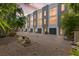 Modern townhouse complex featuring a manicured walkway, gray accents, and beautiful landscaping at 325 5Th S Ave # 9, St Petersburg, FL 33701