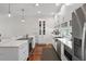 Bright kitchen with white cabinetry, marble countertops, stainless steel appliances, and hardwood flooring at 325 5Th S Ave # 9, St Petersburg, FL 33701