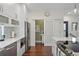 Modern kitchen with white cabinetry, stainless steel appliances, an island, and hardwood flooring at 325 5Th S Ave # 9, St Petersburg, FL 33701