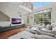 Open concept living room features a soaring ceiling, large windows, hardwood flooring, and modern decor at 325 5Th S Ave # 9, St Petersburg, FL 33701