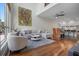 Bright living room boasts high ceilings, hardwood floors, modern furnishings, and an open floor plan into the kitchen at 325 5Th S Ave # 9, St Petersburg, FL 33701