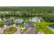 Aerial view showcasing a home with a beautiful water view, manicured lawn, and lush landscaping at 33668 Willow Point Ct, Wesley Chapel, FL 33545