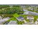 Stunning aerial view of a home with pond views, lush landscaping, and a well-maintained lawn at 33668 Willow Point Ct, Wesley Chapel, FL 33545