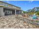 Beautiful outdoor space boasting a paved patio with firepit, complemented by a screened lanai for relaxation and entertainment at 33668 Willow Point Ct, Wesley Chapel, FL 33545