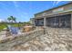 Lovely outdoor area featuring a brick-paved patio, firepit with seating, and a screened lanai for entertaining at 33668 Willow Point Ct, Wesley Chapel, FL 33545
