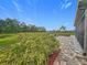 Well-kept backyard with paved patio and built in fire pit seating area at 33668 Willow Point Ct, Wesley Chapel, FL 33545
