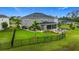 Spacious backyard with lush lawn, decorative landscaping, and an inviting outdoor firepit area at 33668 Willow Point Ct, Wesley Chapel, FL 33545