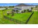 This backyard features a beautiful lawn, a stone patio and fire pit area perfect for outdoor enjoyment at 33668 Willow Point Ct, Wesley Chapel, FL 33545