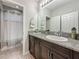 Well-lit bathroom featuring a granite countertop, under-sink cabinetry, and tile flooring at 33668 Willow Point Ct, Wesley Chapel, FL 33545