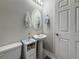 Bathroom with a pedestal sink, oval mirror, and neutral paint at 33668 Willow Point Ct, Wesley Chapel, FL 33545
