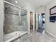 Modern bathroom featuring a tiled shower with glass doors, leading to a separate toilet room for added privacy at 33668 Willow Point Ct, Wesley Chapel, FL 33545