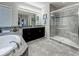 Well-lit bathroom with a soaking tub, dark cabinets and a glass-enclosed shower, offering a relaxing and modern space at 33668 Willow Point Ct, Wesley Chapel, FL 33545