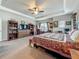 Spacious bedroom features a ceiling fan, large bed, and built-in shelving, providing ample storage and comfort at 33668 Willow Point Ct, Wesley Chapel, FL 33545