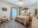Bright bedroom with floral bedding, soft decor, a ceiling fan, and a window, creating a relaxing and inviting atmosphere at 33668 Willow Point Ct, Wesley Chapel, FL 33545