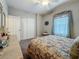 Cozy bedroom with floral bedding, a ceiling fan, and natural light, offering a peaceful retreat for relaxation at 33668 Willow Point Ct, Wesley Chapel, FL 33545
