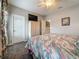 Well-lit bedroom featuring a ceiling fan, floral bedding, and ample closet space, creating a comfortable and organized retreat at 33668 Willow Point Ct, Wesley Chapel, FL 33545