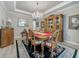 Elegant dining room features hardwood floors, stylish chandelier, and a built-in china cabinet for formal dinners at 33668 Willow Point Ct, Wesley Chapel, FL 33545