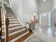 Welcoming foyer with a staircase, soaring ceilings, and pristine hardwood floors, offering a grand entrance at 33668 Willow Point Ct, Wesley Chapel, FL 33545