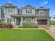 Charming two-story home with landscaped yard, blue shutters, and two-car garage in a desirable neighborhood at 33668 Willow Point Ct, Wesley Chapel, FL 33545