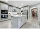 Spacious kitchen features a center island with granite countertop and stainless steel appliances at 33668 Willow Point Ct, Wesley Chapel, FL 33545