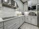 Close-up on modern kitchen appliances and stylish backsplash in renovated kitchen at 33668 Willow Point Ct, Wesley Chapel, FL 33545
