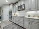 Modern kitchen with stainless steel appliances, white cabinetry, granite countertops, and stylish backsplash at 33668 Willow Point Ct, Wesley Chapel, FL 33545
