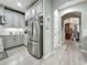 Bright kitchen features stainless steel refrigerator, granite countertops, and gray cabinets at 33668 Willow Point Ct, Wesley Chapel, FL 33545