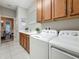 Functional laundry room with washer, dryer, sink, and cabinets at 33668 Willow Point Ct, Wesley Chapel, FL 33545