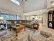 Open-concept living room features hardwood floors, soaring ceilings, and an open layout to the kitchen at 33668 Willow Point Ct, Wesley Chapel, FL 33545