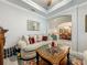 Bright living room area with an elegant sofa set, decorative fireplace, and an archway to the dining room at 33668 Willow Point Ct, Wesley Chapel, FL 33545