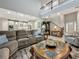 Open living room with light gray walls, hardwood flooring, and a gray sectional sofa at 33668 Willow Point Ct, Wesley Chapel, FL 33545