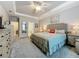 Spacious main bedroom showcases a tray ceiling, neutral paint and ensuite bathroom at 33668 Willow Point Ct, Wesley Chapel, FL 33545