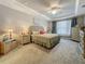 Main bedroom features neutral decor, tray ceiling, and soft lighting at 33668 Willow Point Ct, Wesley Chapel, FL 33545