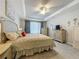 The main bedroom features neutral paint, tray ceilings and soft natural light at 33668 Willow Point Ct, Wesley Chapel, FL 33545