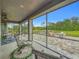 Screened patio overlooking a paved fire pit area and green backyard at 33668 Willow Point Ct, Wesley Chapel, FL 33545