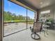 Covered patio with view of paved backyard and outdoor kitchen at 33668 Willow Point Ct, Wesley Chapel, FL 33545
