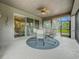 Screened lanai featuring outdoor dining set and ceiling fan at 33668 Willow Point Ct, Wesley Chapel, FL 33545
