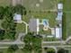 A birds-eye view of the property featuring a pool, barn, storage shed and home at 3412 Ace Ln, Dover, FL 33527