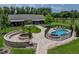 Aerial view of backyard featuring a pool, fire pit, and beautifully landscaped grounds, perfect for outdoor entertaining at 3412 Ace Ln, Dover, FL 33527