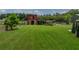 Picturesque red barn on a well-maintained lawn, perfect for equestrian pursuits or rural living at 3412 Ace Ln, Dover, FL 33527