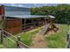Exterior view of a barn with a play structure, showcasing the farm's recreational and functional spaces at 3412 Ace Ln, Dover, FL 33527