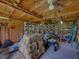 Barn interior with hay bales, tools and equipment, offering a functional space for storage or livestock at 3412 Ace Ln, Dover, FL 33527