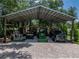 Well-organized barn area showcasing farm equipment and vehicles, providing ample covered space at 3412 Ace Ln, Dover, FL 33527