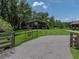 View of the property entrance and barn featuring a gated entrance and paved driveway at 3412 Ace Ln, Dover, FL 33527